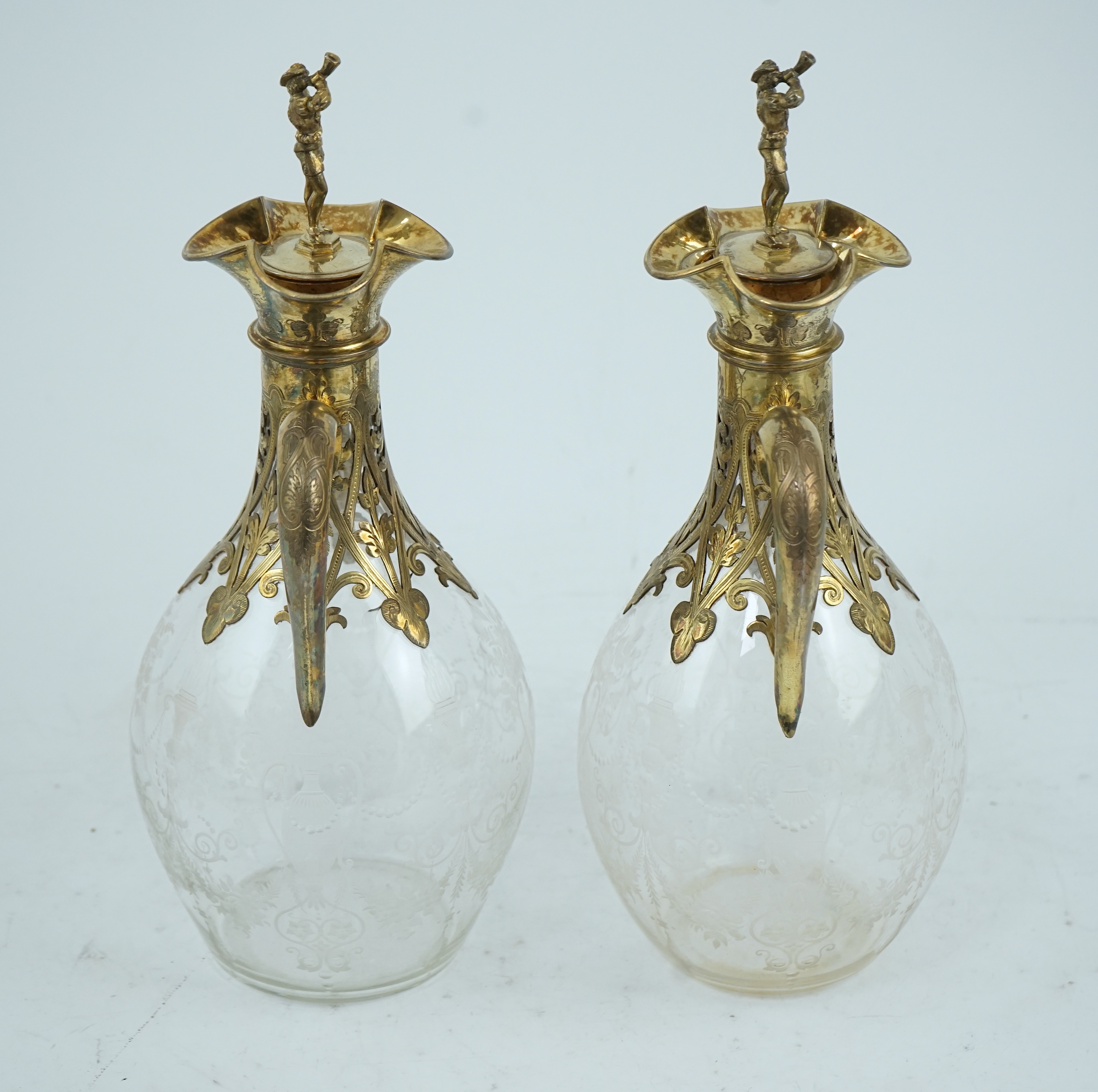 A good pair of Victorian silver gilt mounted wheel engraved glass two handled decanters and stoppers, by George Fox